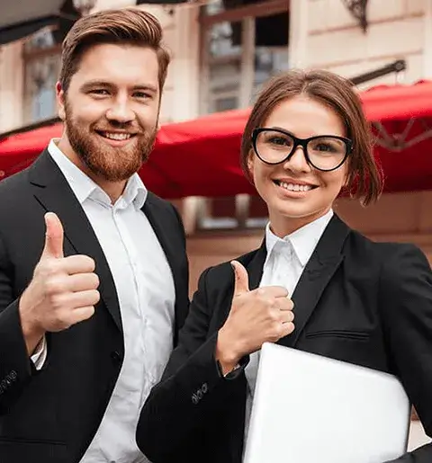 Two business people giving thumbs up.